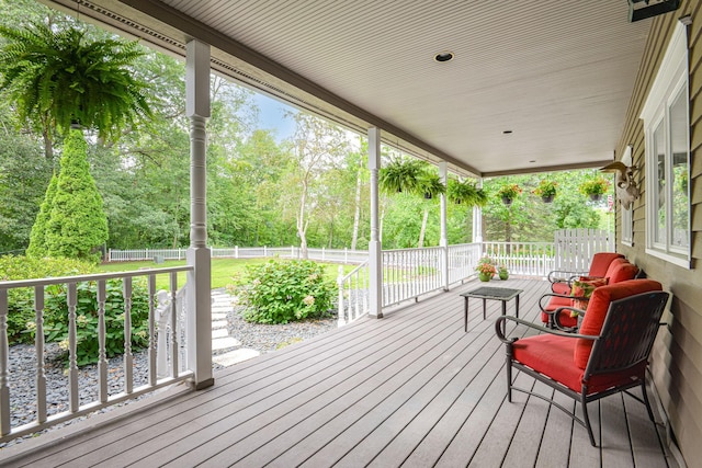 10069 Stacy Trl, Chisago City, MN 55013 - wooden terrace featuring covered porch, fence, and view of wooded area