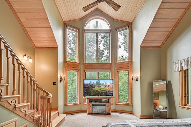 10069 Stacy Trl, Chisago City, MN 55013 - carpeted living area featuring high vaulted ceiling, wooden ceiling, ceiling fan, stairs, and baseboards
