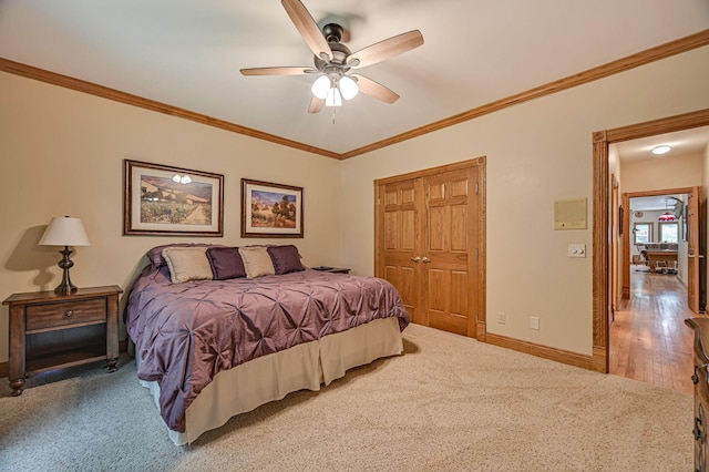 10069 Stacy Trl, Chisago City, MN 55013 - carpeted bedroom with crown molding, a closet, baseboards, and ceiling fan