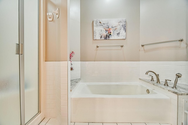 10069 Stacy Trl, Chisago City, MN 55013 - full bathroom with a garden tub, tile patterned floors, and a stall shower