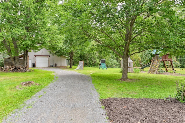 10069 Stacy Trl, Chisago City, MN 55013 - view of front facade with an outbuilding, a playground, driveway, and a front yard