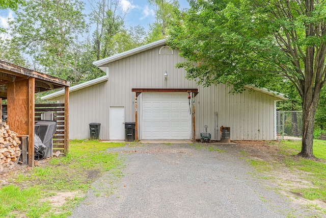 10069 Stacy Trl, Chisago City, MN 55013 - view of outdoor structure featuring fence, an outdoor structure, and asphalt driveway