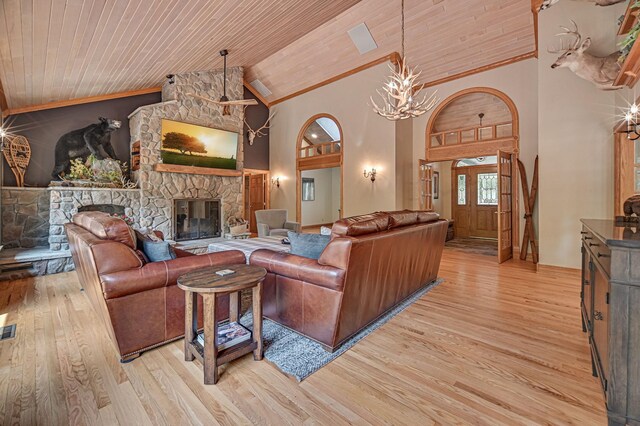 10069 Stacy Trl, Chisago City, MN 55013 - living area with wood ceiling, light wood-style floors, a fireplace, a chandelier, and high vaulted ceiling