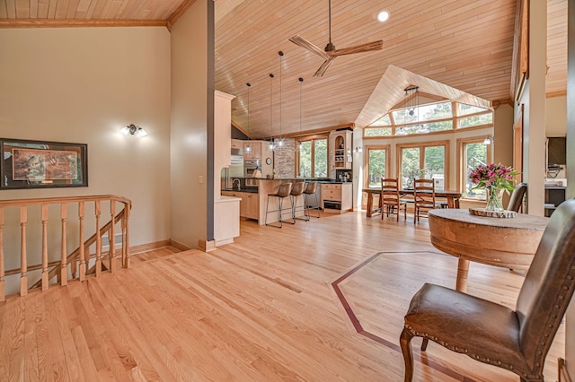 10069 Stacy Trl, Chisago City, MN 55013 - living room featuring wooden ceiling, high vaulted ceiling, baseboards, ceiling fan, and light wood-type flooring