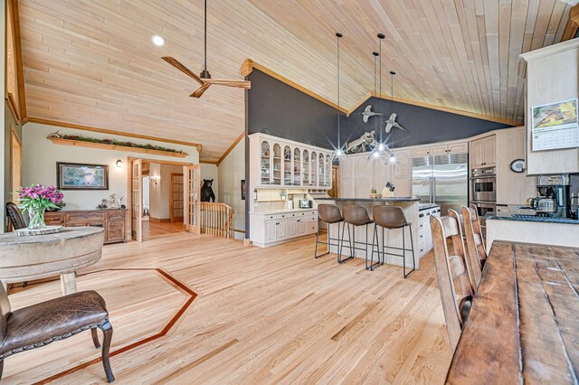 10069 Stacy Trl, Chisago City, MN 55013 - dining room featuring wood ceiling, high vaulted ceiling, ceiling fan, light wood-type flooring, and crown molding