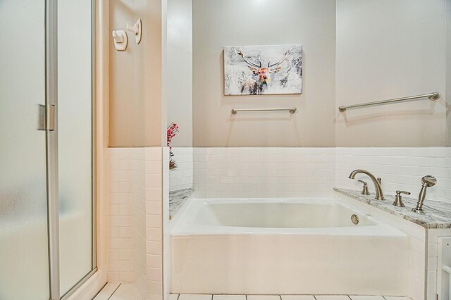 10069 Stacy Trl, Chisago City, MN 55013 - full bathroom featuring a bath, a shower stall, and tile patterned flooring