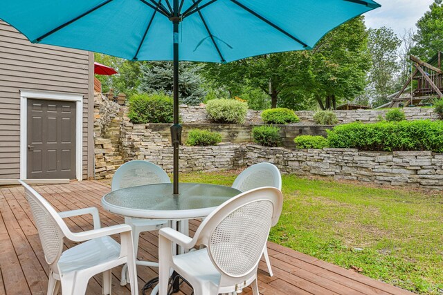 10069 Stacy Trl, Chisago City, MN 55013 - deck featuring outdoor dining space and a lawn
