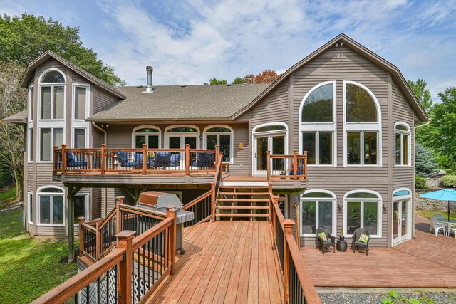 10069 Stacy Trl, Chisago City, MN 55013 - rear view of property with a deck, a shingled roof, and stairway