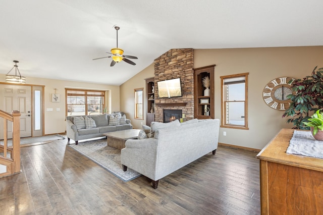 living area with baseboards, ceiling fan, lofted ceiling, a fireplace, and hardwood / wood-style flooring
