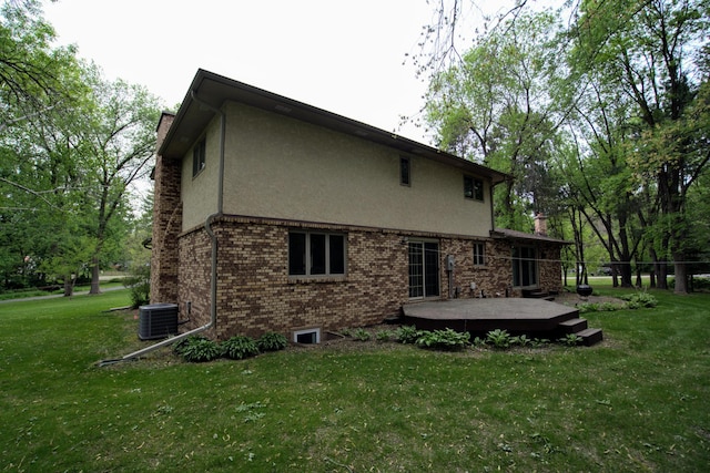 2342 75th Ave, Princeton, MN 55371 - rear view of house with a chimney, central AC unit, stucco siding, and a lawn