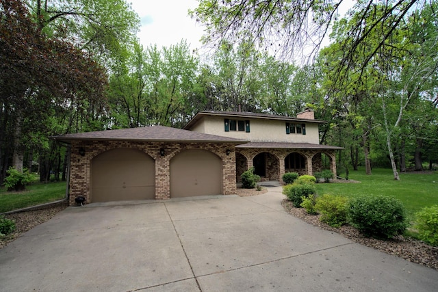 2342 75th Ave, Princeton, MN 55371 - traditional-style house featuring a garage, driveway, a front lawn, a chimney, and brick siding