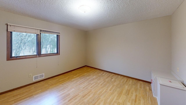 2342 75th Ave, Princeton, MN 55371 - empty room with light wood finished floors, baseboards, and a textured ceiling