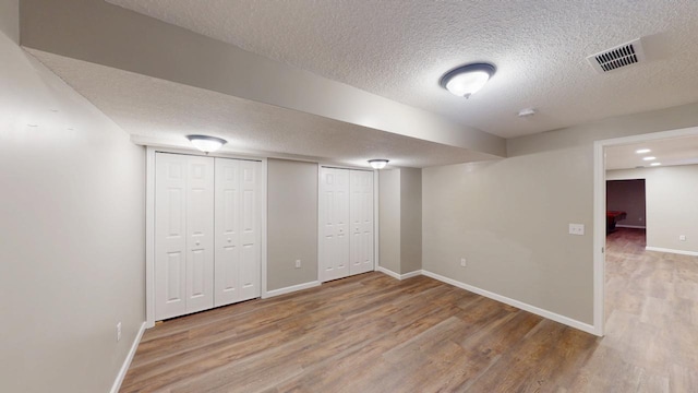 2342 75th Ave, Princeton, MN 55371 - finished basement with a textured ceiling, wood finished floors, and baseboards