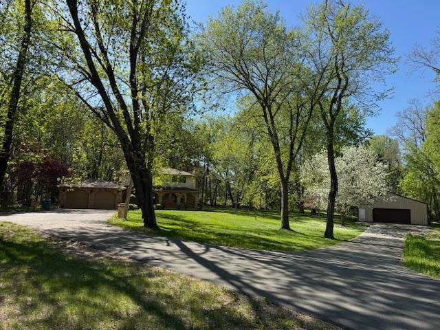 2342 75th Ave, Princeton, MN 55371 - view of property's community featuring a garage, an outdoor structure, and a lawn