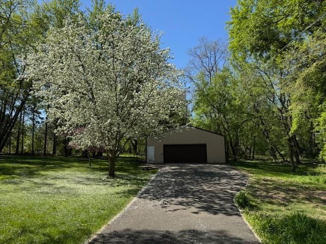 2342 75th Ave, Princeton, MN 55371 - view of front of house with an outdoor structure, a detached garage, a front lawn, and asphalt driveway