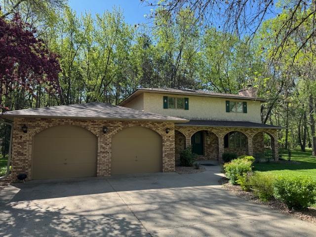 2342 75th Ave, Princeton, MN 55371 - view of front of property with a garage, concrete driveway, a chimney, and brick siding