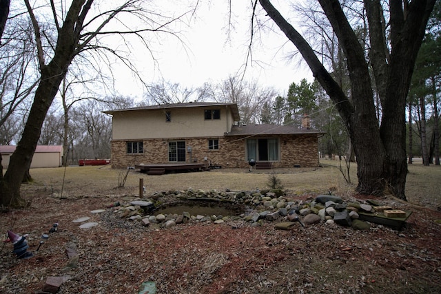 2342 75th Ave, Princeton, MN 55371 - rear view of property with stucco siding, brick siding, and a deck
