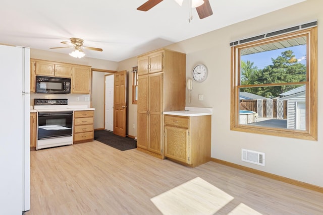 9904 95th Ave N, Maple Grove, MN 55369 - kitchen with black microwave, electric stove, a ceiling fan, and freestanding refrigerator