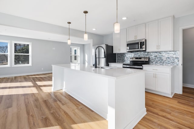 1903 Thomas Ave N, Minneapolis, MN 55411 - kitchen with a sink, decorative backsplash, stainless steel appliances, light wood finished floors, and light countertops