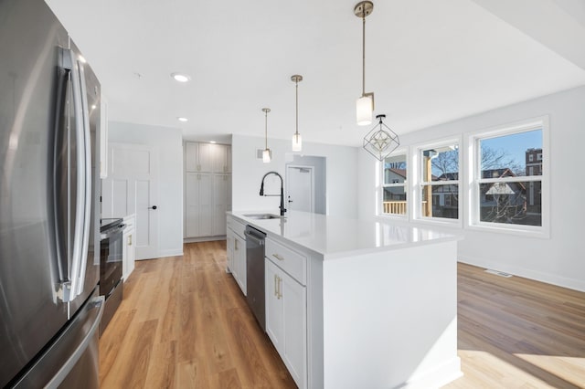 1903 Thomas Ave N, Minneapolis, MN 55411 - kitchen with stainless steel appliances, visible vents, a sink, and light wood-style floors
