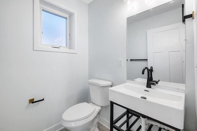 1903 Thomas Ave N, Minneapolis, MN 55411 - half bathroom with baseboards, toilet, and a sink
