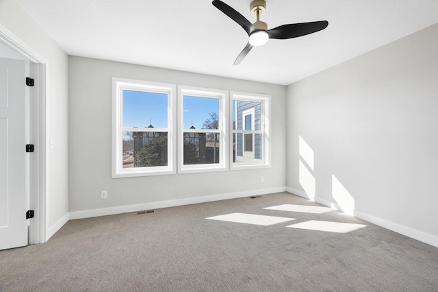 1903 Thomas Ave N, Minneapolis, MN 55411 - carpeted empty room featuring baseboards, visible vents, and ceiling fan
