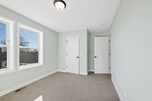 1903 Thomas Ave N, Minneapolis, MN 55411 - unfurnished bedroom with baseboards, visible vents, and carpet