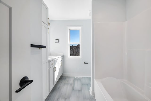 1903 Thomas Ave N, Minneapolis, MN 55411 - full bath featuring vanity, a tub, a shower, baseboards, and visible vents