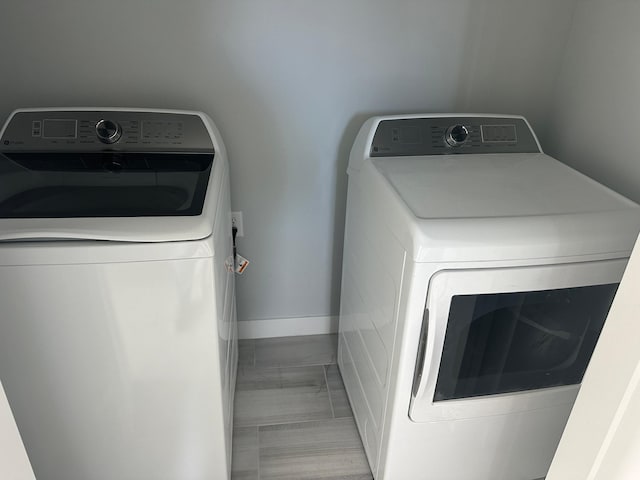 1903 Thomas Ave N, Minneapolis, MN 55411 - washroom with washing machine and clothes dryer and baseboards