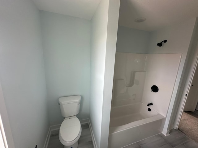 1903 Thomas Ave N, Minneapolis, MN 55411 - bathroom with toilet, tub / shower combination, and baseboards