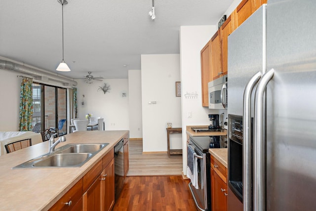 4525 Park Commons Dr Unit 221, Saint Louis Park, MN 55416 - kitchen with brown cabinets, a sink, stainless steel appliances, dark wood-style flooring, and light countertops