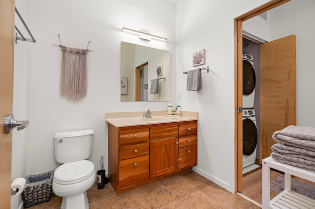 4525 Park Commons Dr Unit 221, Saint Louis Park, MN 55416 - bathroom featuring stacked washer / dryer, vanity, toilet, and tile patterned floors