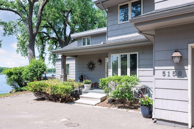 5150 Meadville St, Greenwood, MN 55331 - doorway to property featuring a water view and roof with shingles