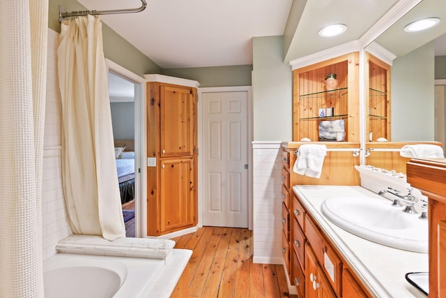 5150 Meadville St, Greenwood, MN 55331 - bathroom with vanity, hardwood / wood-style floors, recessed lighting, and tile walls