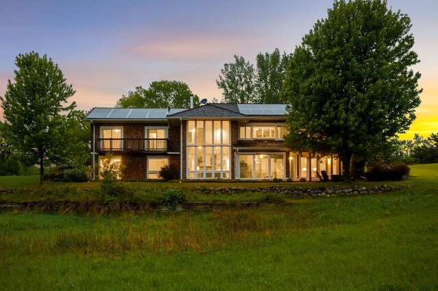 12697 177th St N, May Twp, MN 55047 - back of house at dusk with roof mounted solar panels and brick siding