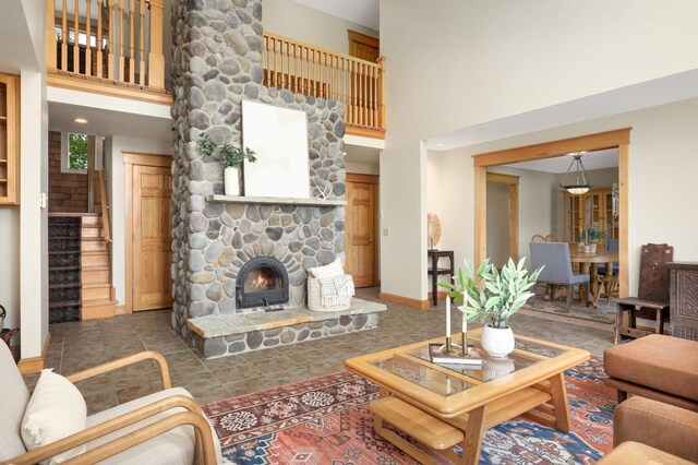 12697 177th St N, May Twp, MN 55047 - living area featuring a high ceiling, a fireplace, stairway, baseboards, and tile patterned floors