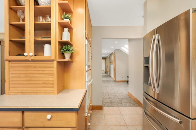 12697 177th St N, May Twp, MN 55047 - kitchen with stainless steel fridge, open shelves, baseboards, light countertops, and light tile patterned floors