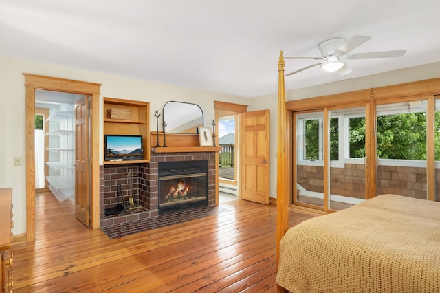 12697 177th St N, May Twp, MN 55047 - bedroom featuring a fireplace, wood-type flooring, and access to outside