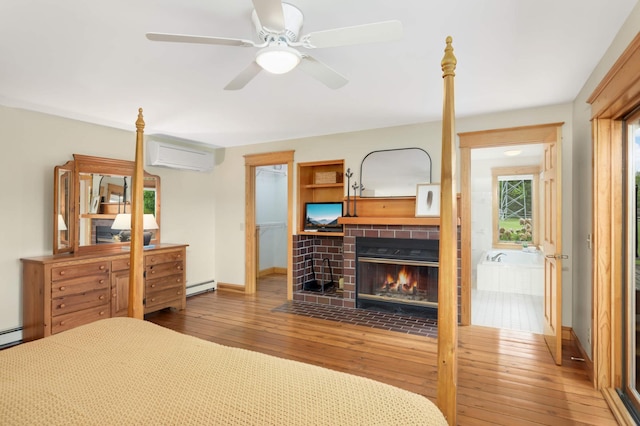 12697 177th St N, May Twp, MN 55047 - bedroom with an AC wall unit, hardwood / wood-style flooring, a brick fireplace, a baseboard radiator, and baseboards