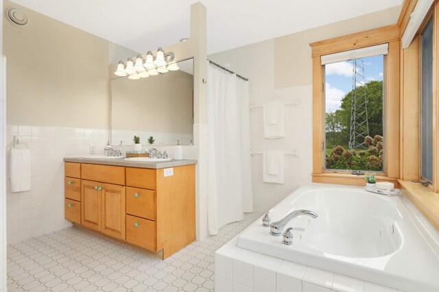 12697 177th St N, May Twp, MN 55047 - full bathroom with a tub with jets, double vanity, tile walls, and wainscoting