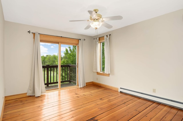 12697 177th St N, May Twp, MN 55047 - spare room featuring baseboard heating, ceiling fan, baseboards, and light wood finished floors