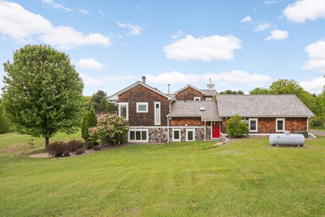 12697 177th St N, May Twp, MN 55047 - rear view of property with a lawn, a chimney, and stone siding