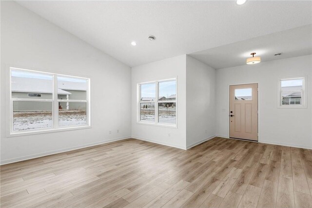 260 Spring St, Osceola, WI 54020 - foyer with baseboards, recessed lighting, vaulted ceiling, and light wood-style floors