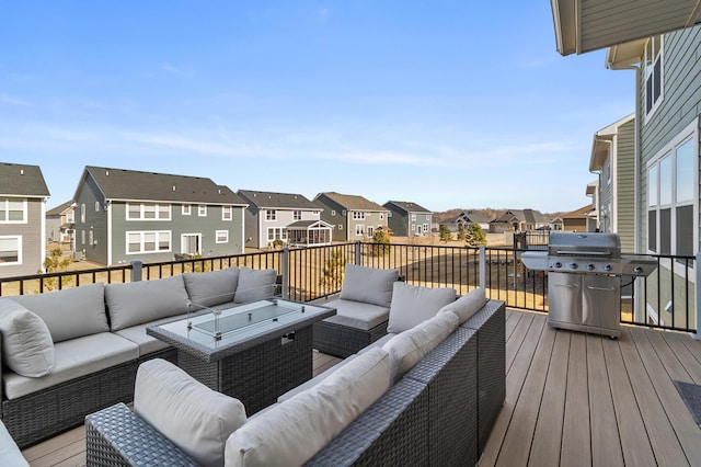 wooden deck featuring outdoor lounge area, a residential view, and area for grilling