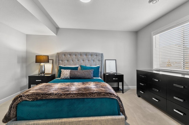 bedroom featuring baseboards and light colored carpet
