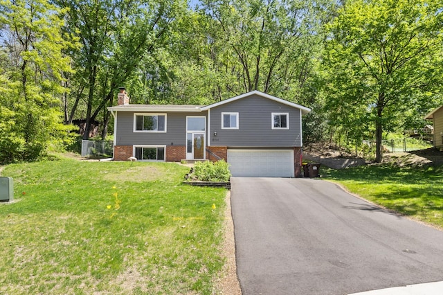 12701 Pheasant Run, Burnsville, MN 55337 - raised ranch featuring brick siding, a chimney, driveway, and an attached garage