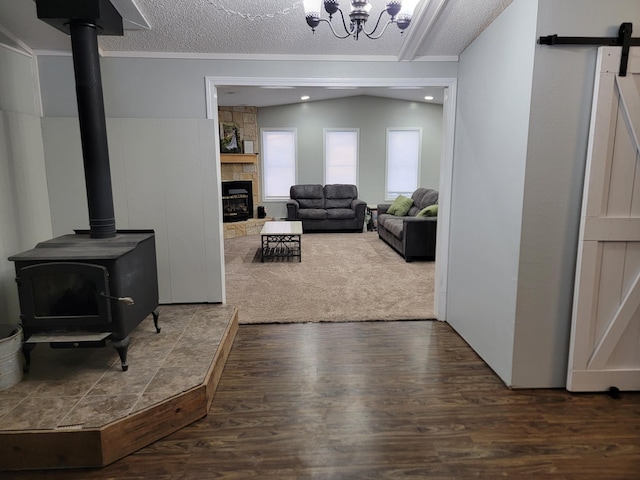 29829 400th Ave, Roseau, MN 56751 - living room featuring wood finished floors, a wood stove, a barn door, and a chandelier