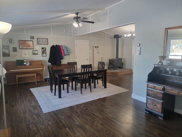 29829 400th Ave, Roseau, MN 56751 - dining room with ceiling fan, a wood stove, dark wood-style floors, vaulted ceiling, and a textured ceiling