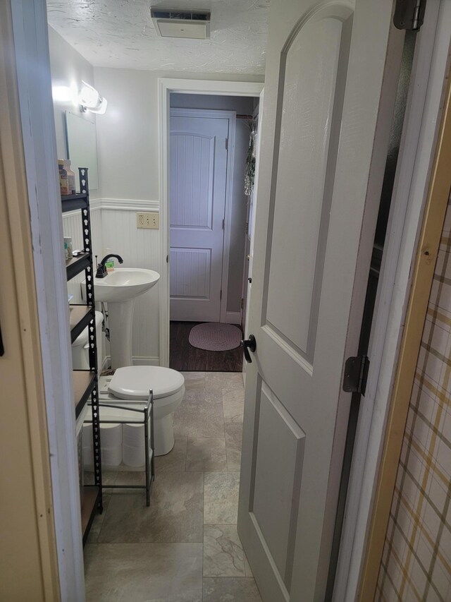 29829 400th Ave, Roseau, MN 56751 - half bath featuring wainscoting and toilet