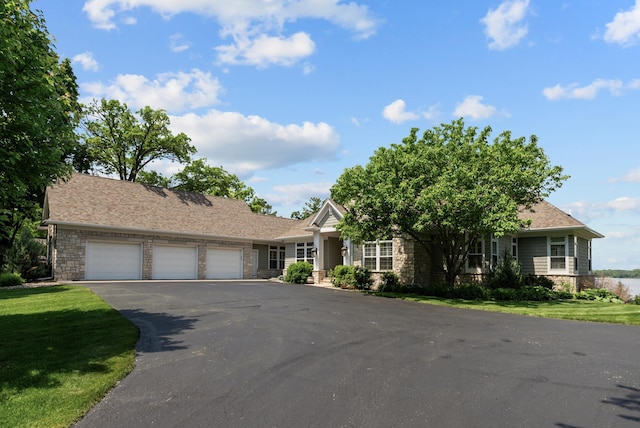 1505 Edgewater Ave, Arden Hills, MN 55112 - view of front of property with a garage, stone siding, driveway, and a front lawn